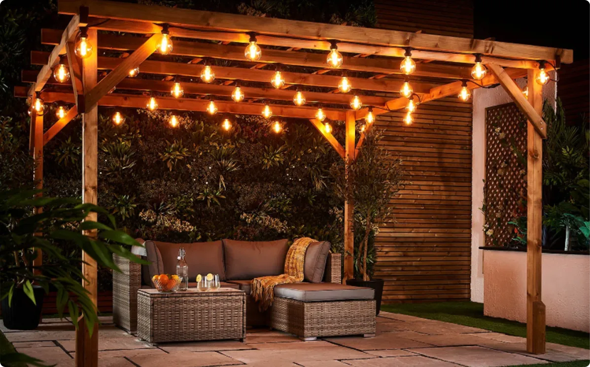 Industrial Edison bulb string lights with exposed filaments for a rustic farmhouse pergola aesthetic
