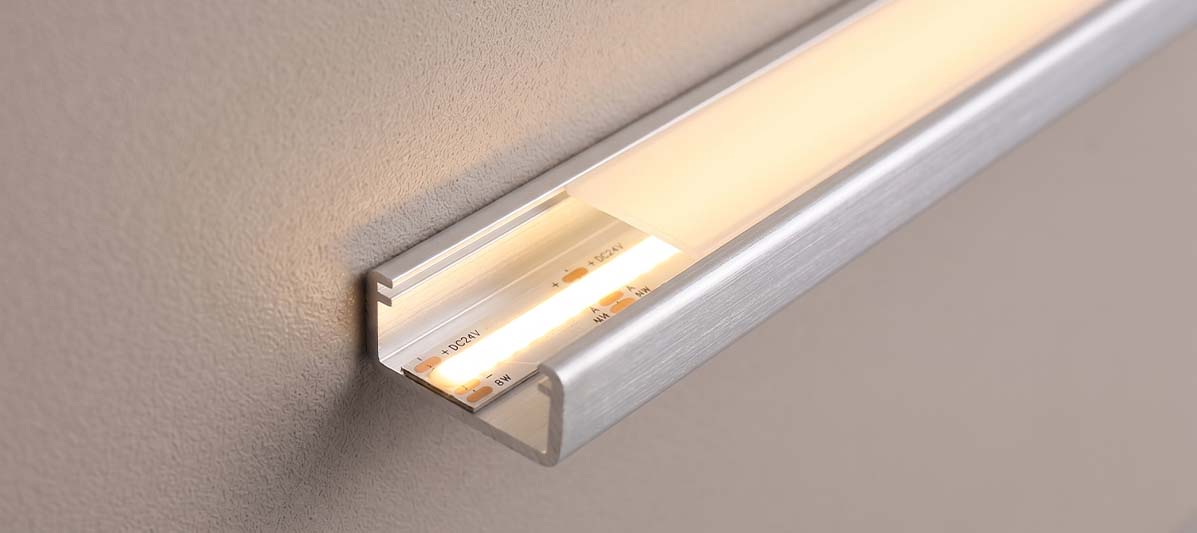 Close-up of a high-efficiency single white 3000K LED strip mounted in an aluminum alloy profile channel, emitting warm white light with uniform brightness at over 1000 lumens per meter
